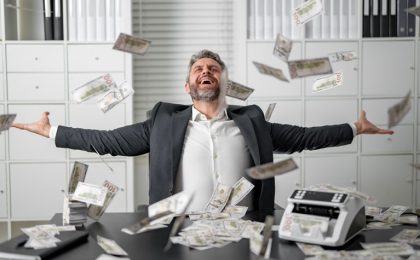 Businessman throwing dollar bills in the air with excitement. Excited man throwing falling cash. Rich business man throwing dollar bills. Handsome man throwing cash while money.