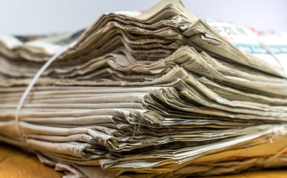 Tied pack of paper newspapers on wooden table