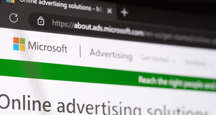 Close-up of the Microsoft Advertising website shown on a computer monitor, highlighting Microsoft’s logo and the browser address bar for about.ads.microsoft.com.