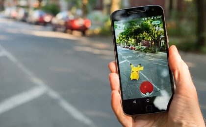 Montreal, CA - July 28, 2016: Closeup of a man playing Pokemon Go on a smart phone. Pokemon Go is a virtual reality game released in July 2016.
