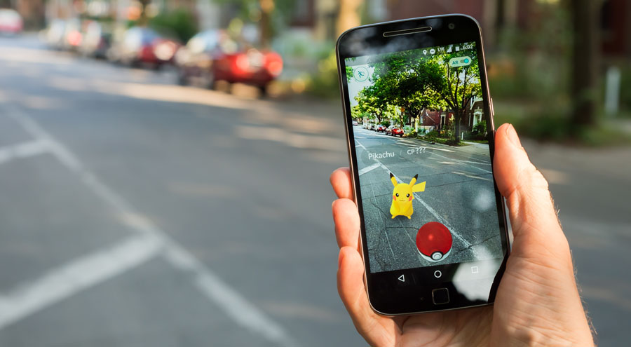 Montreal, CA - July 28, 2016: Closeup of a man playing Pokemon Go on a smart phone. Pokemon Go is a virtual reality game released in July 2016.