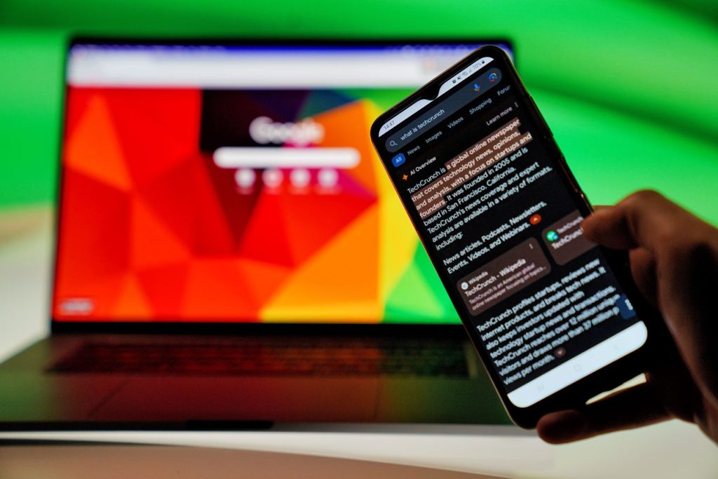 A smartphone displays an AI-generated answer in a search results page, illustrating how businesses are beginning to track what AI tools say about their brands and competitors. That monitoring can help guide efforts to improve their chances of being cited or recommended. Photo: DIA TV.